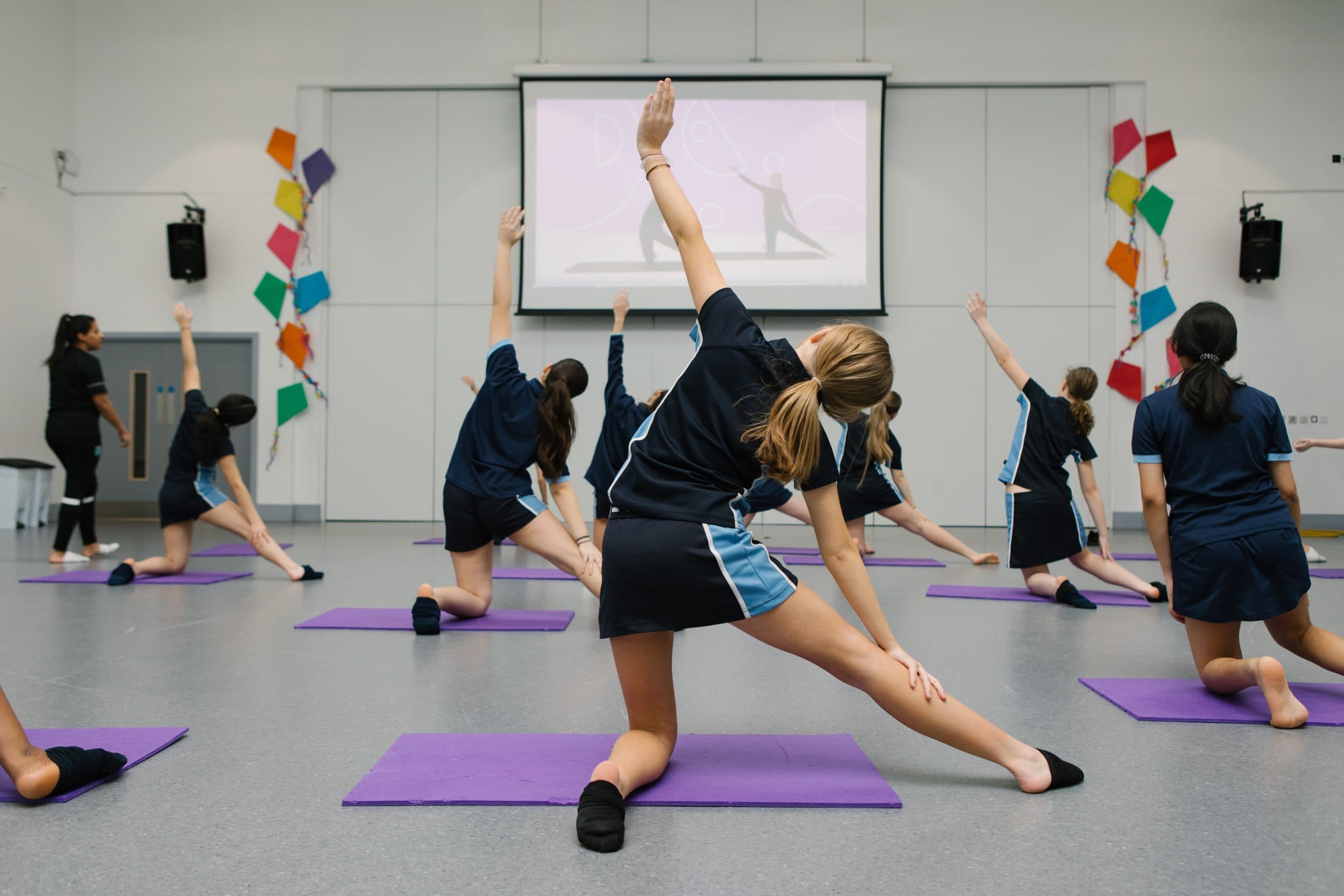 A group of teenage girls in a Studio You yoga class