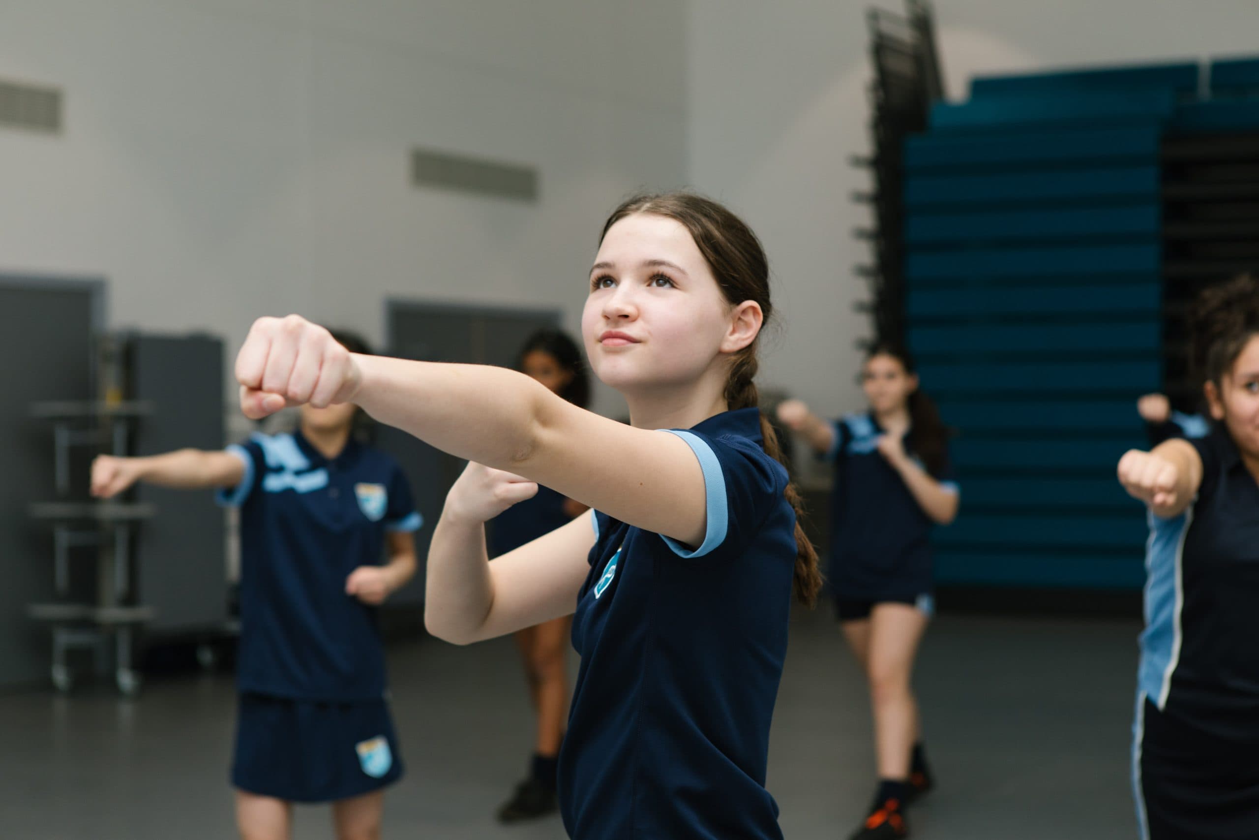 Teenage girl smiling in a boxing pose